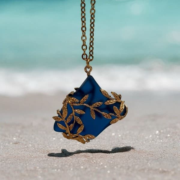 Cobalt blue sea glass pendant on the beach